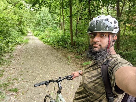 hussain taking a selfie on a bicycle